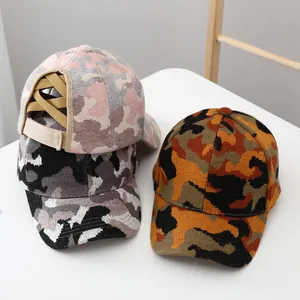 Detail of camouflage knit ponytail hats with criss-cross elastic bands and velcro straps