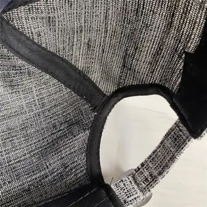 Detail of grey mesh fabric and neat stitching on a diamond-encrusted baseball cap