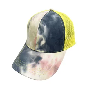Dettaglio cappello trucker tie-dye con rete gialla e cuciture a contrasto sulla visiera