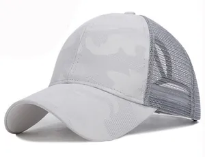 Close-up of light grey camouflage pattern and breathable mesh texture on ponytail baseball cap