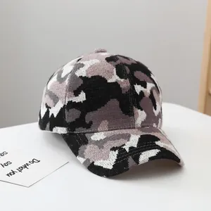 Detail of winter camouflage knit baseball cap showing thick texture and curved brim