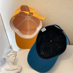 Detail view of cotton baseball caps with metal buckle and internal stitching