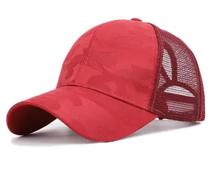Close-up of red camo mesh trucker hat with breathable fabric and curved brim
