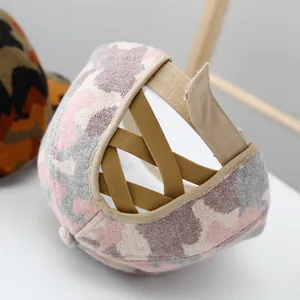 Detail of camouflage knitted baseball cap with elastic criss-cross back and velcro strap