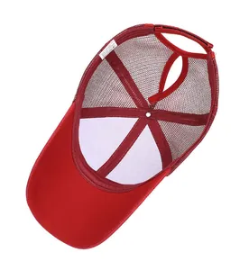 Detail of red ponytail mesh hat showing washing label with 65% cotton and 35% polyester
