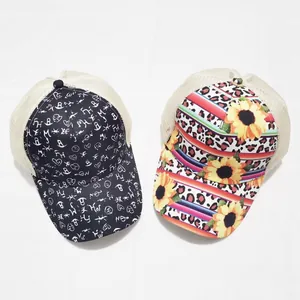 Detail of printed tie-dye mesh ponytail baseball caps with graffiti and sunflower patterns