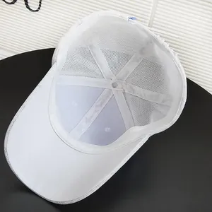 Detail view of the breathable white mesh fabric and inner structure of the baseball cap