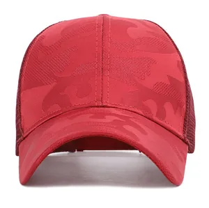 Detail of red camouflage mesh baseball cap with breathable fabric and curved visor