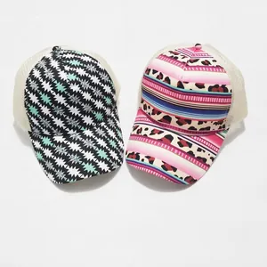 Close-up of printed tie-dye mesh ponytail baseball caps with tribal and leopard patterns