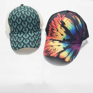 Detail of floral and tie-dye ponytail trucker hats with breathable mesh back panels