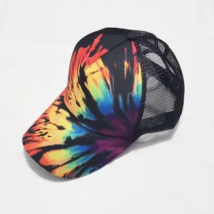 Detail view of tie-dye ponytail baseball cap featuring black mesh and vibrant patterns