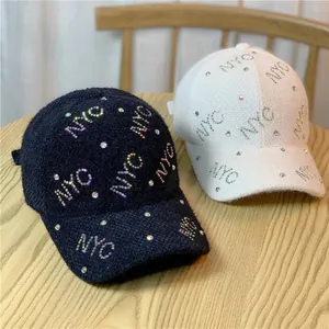 Chic winter baseball caps in black and white with sparkling NYC rhinestone decoration