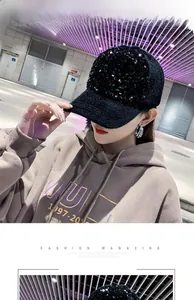 Detail of black mohair baseball cap with shimmering sequins worn by a model in casual style