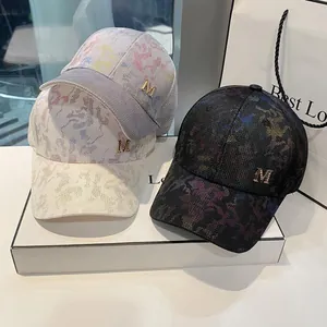 Camo baseball cap with rhinestone M logo and metallic beaded brim in three colors