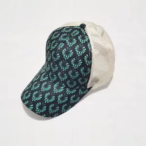 Detail of teal floral print on front panel and breathable off-white mesh on trucker hat