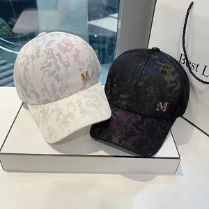 Jacquard baseball cap with gold metal M logo in dark and light camouflage patterns
