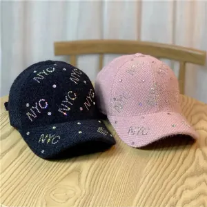 Fashionable tweed baseball caps with rhinestone NYC lettering in black and pink colors