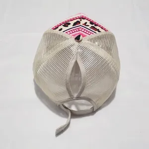 Detail of breathable mesh back and vertical ponytail hole on tie-dye baseball cap