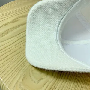 Close-up of white plush baseball cap showing detailed stitching and warm fleece texture