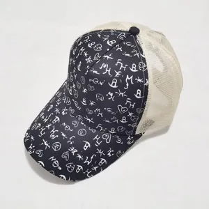 Close-up of printed tie-dye trucker hat featuring graffiti patterns and mesh back detail