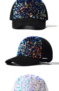 Detailed view of colorful sequins on mohair baseball caps in black and white colors