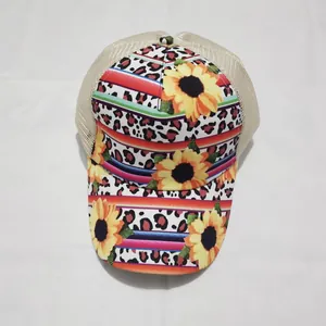 Detailed view of tie-dye trucker hat featuring sunflower and leopard print patterns