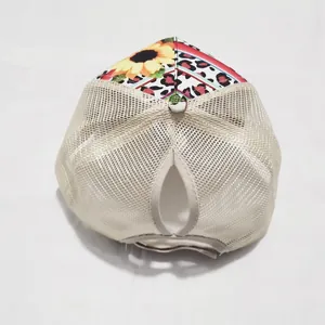Detail view of sunflower print ponytail baseball cap with breathable beige mesh back
