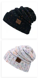 Close-up of knit beanies with colorful specks and C.C leather patch detail