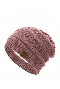 Detail view of pink knit beanie showing warm fleece lining and star leather patch