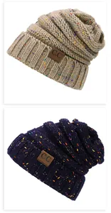Close-up of knit texture and faux leather logo patch on multicolor speckled beanie