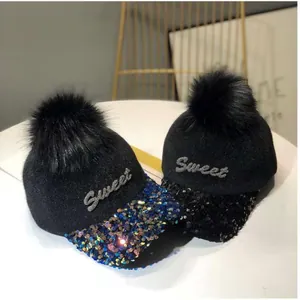 Vista detallada del bordado Sweet y las lentejuelas brillantes en estas gorras de invierno
