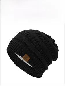 Detail view of black knit beanie with warm fleece lining and star leather patch