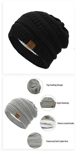Detail of cable knit beanie with thick fleece lining and star faux leather patch