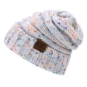 White speckled knit beanie with CC leather patch and ribbed cuff for outdoor warmth