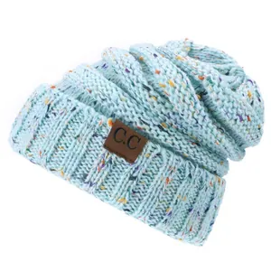 Light blue speckled knit beanie with C.C faux leather patch for winter warmth