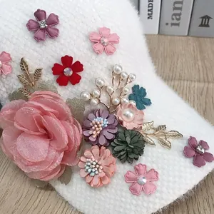 Close-up of floral baseball cap featuring pink fabric flowers and pearl embellishments
