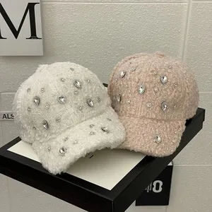 Fuzzy faux fur baseball caps with rhinestone accents in cream and light pink colors
