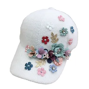 White knit baseball cap with 3D floral embroidery and rhinestone accents for winter