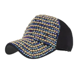 Detail of black baseball cap with golden rivets and colorful gradient rhinestones