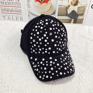 Detail of black faux mink baseball cap with hand-set pearls and sparkling rhinestones