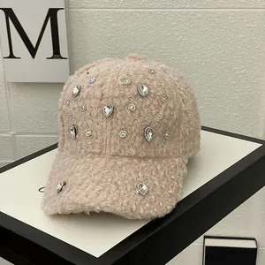 Close-up of pink fleece baseball cap featuring sparkly rhinestones for autumn winter
