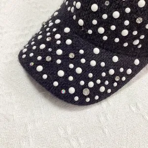 Detail of winter knit baseball cap featuring hand-set pearls and shimmering rhinestones