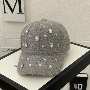 Detail of grey fleece baseball cap with sparkling rhinestones and plush texture