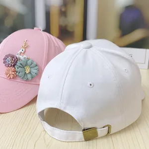 Detail of floral baseball cap showing 3D flowers, deer ornament and adjustable metal buckle