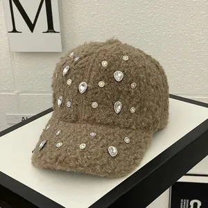Detail of brown teddy fleece baseball cap featuring luxurious crystal rhinestone embellishments