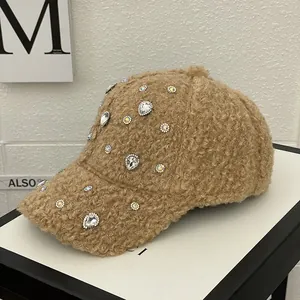 Detail of brown teddy fleece baseball cap with colorful rhinestones and soft texture