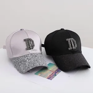 Chic satin baseball caps with sequined brims and rhinestone D logo in black and silver