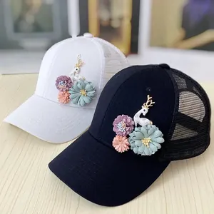Detail of mesh baseball cap featuring 3D floral appliques and a cute deer motif