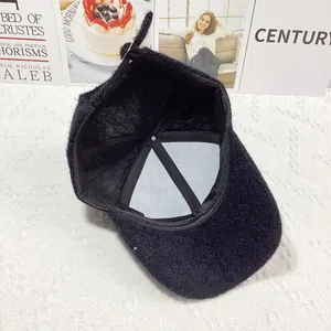 Interior detail of black faux mink fur baseball cap showing stitching and inner lining