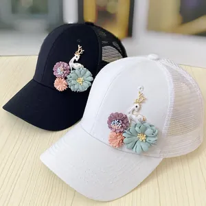 Detail of handmade 3D flower applique and deer ornament on breathable mesh baseball caps